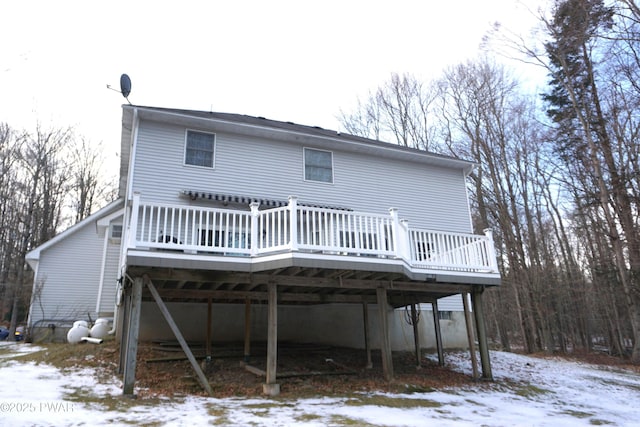 snow covered house featuring a deck