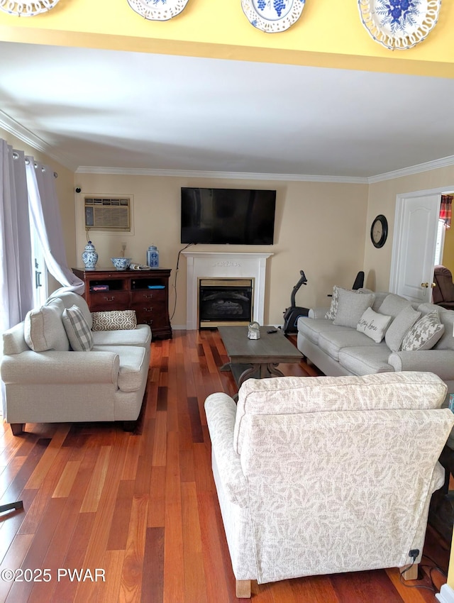 living room with ornamental molding, a wall mounted air conditioner, and hardwood / wood-style floors