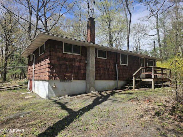 118 Tulip St, Dingmans Ferry, PA 18328 - view of side of property with a chimney and a wooden deck