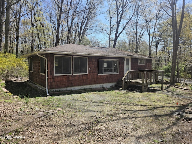 118 Tulip St, Dingmans Ferry, PA 18328 - view of front facade featuring roof with shingles and a deck