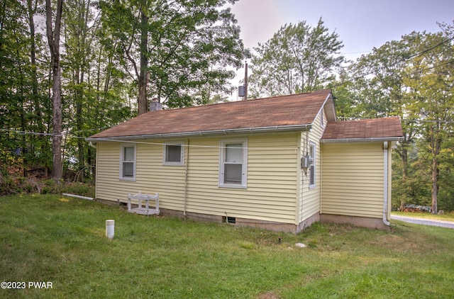 view of property exterior featuring a lawn