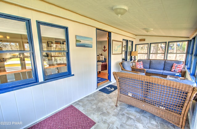 sunroom featuring vaulted ceiling