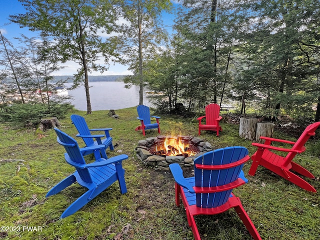 view of yard with a fire pit and a water view