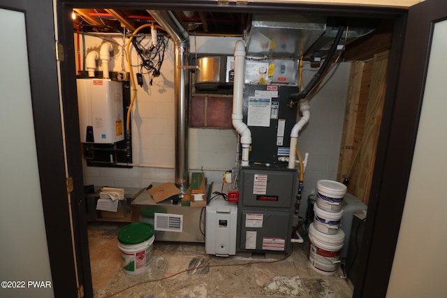 utility room featuring water heater