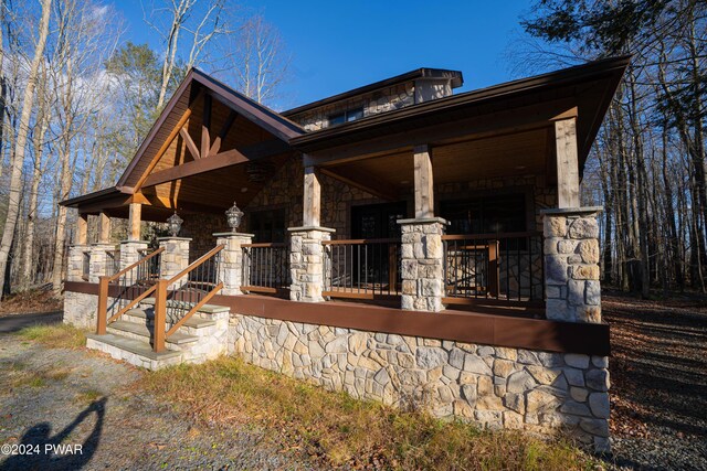 view of side of home with a porch