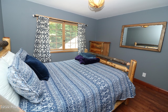 bedroom with dark wood-type flooring