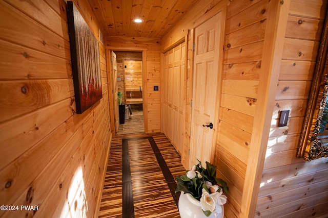 hall featuring wood walls and wooden ceiling