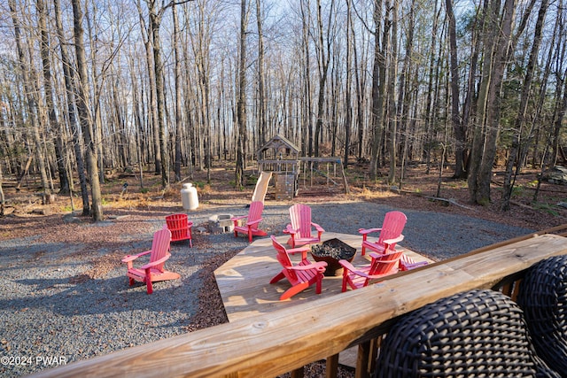 exterior space featuring a playground and an outdoor fire pit