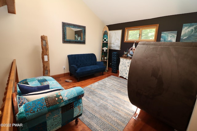 living room featuring hardwood / wood-style flooring and lofted ceiling