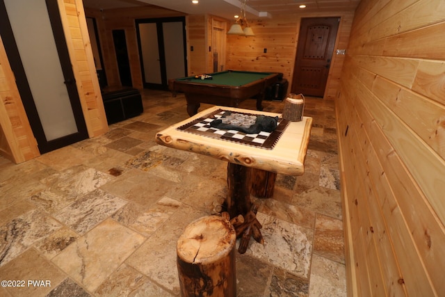 rec room with wood walls and billiards