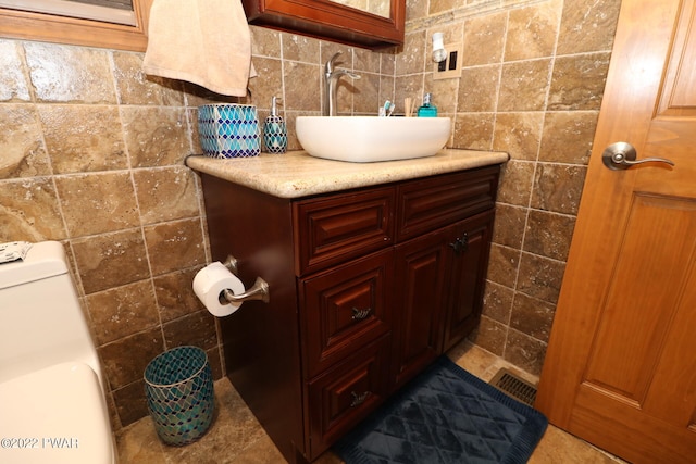 bathroom featuring washer / clothes dryer, vanity, and toilet