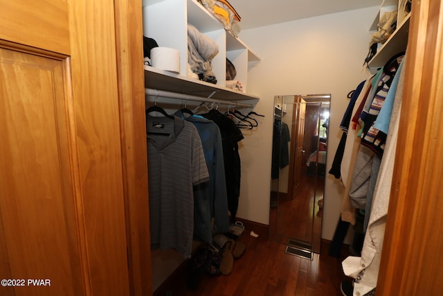 spacious closet featuring dark hardwood / wood-style floors