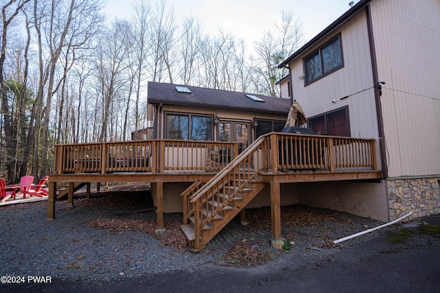 back of house featuring a wooden deck