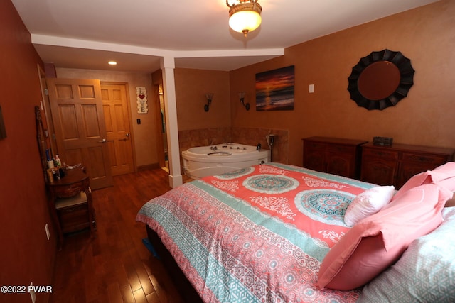 bedroom with a closet and dark wood-type flooring