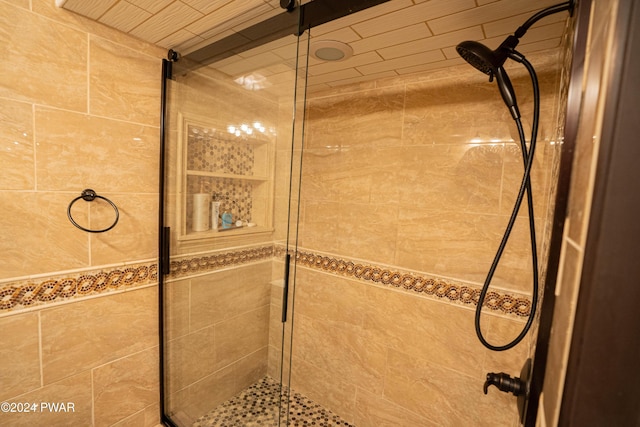 bathroom featuring a shower with door