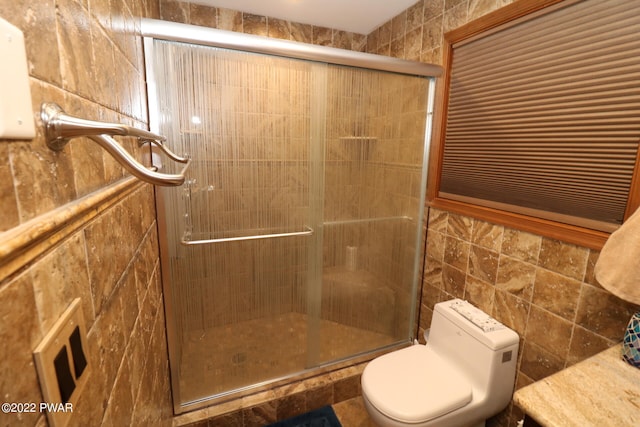 bathroom with an enclosed shower and toilet