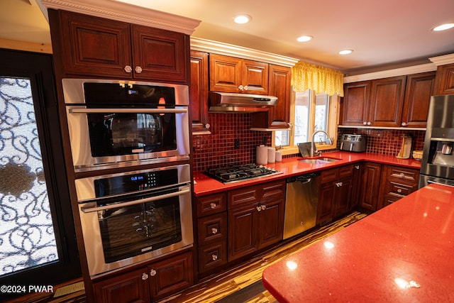 kitchen with tasteful backsplash, sink, and stainless steel appliances