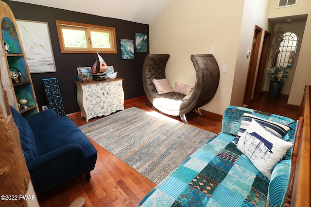 living area with hardwood / wood-style floors and lofted ceiling