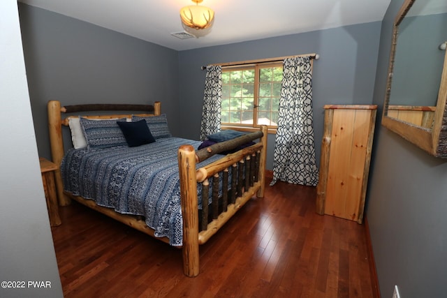 bedroom with dark wood-type flooring