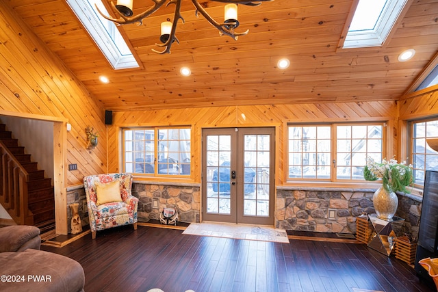 living area featuring a skylight, french doors, wooden ceiling, and hardwood / wood-style flooring