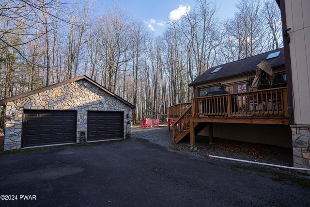 view of home's exterior featuring a garage and a deck