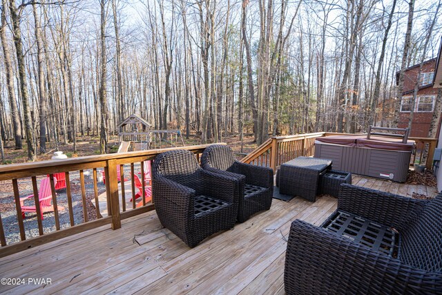 deck with a playground and a hot tub