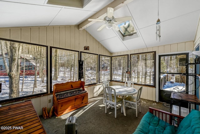 sunroom / solarium with lofted ceiling with skylight and ceiling fan