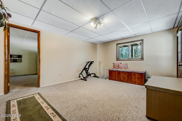 interior space with a paneled ceiling and carpet