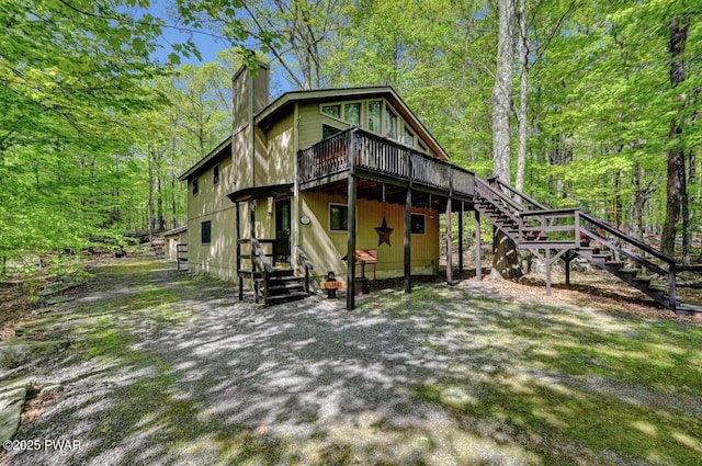 7 Huron Ct Lot 4196, Lake Ariel, PA 18436 - view of front of home featuring stairs, a chimney, a deck, and a wooded view