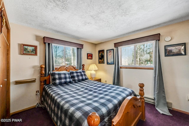 bedroom with baseboard heating, a textured ceiling, dark carpet, and a closet