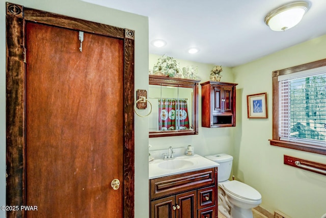 bathroom featuring vanity and toilet