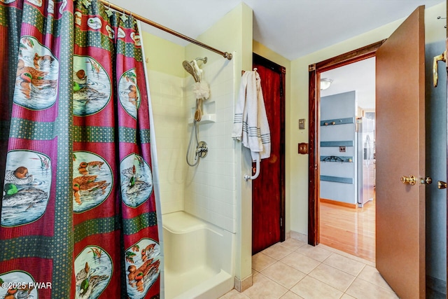 bathroom featuring tile patterned flooring and a shower with shower curtain