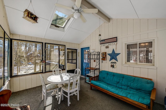 sunroom with a wealth of natural light, vaulted ceiling with skylight, and ceiling fan