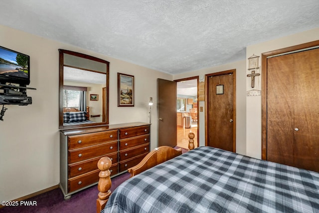 bedroom featuring dark colored carpet, a textured ceiling, and a closet