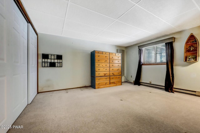 unfurnished bedroom with carpet floors and a drop ceiling