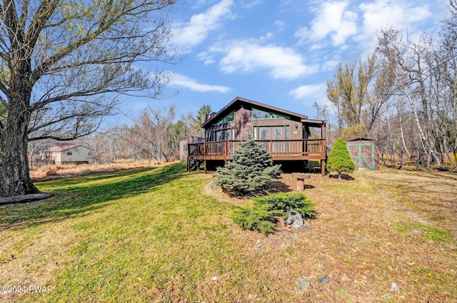 exterior space featuring a storage unit, a deck, and a yard