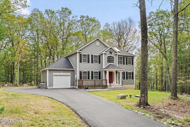 view of front of house with a front lawn and a garage