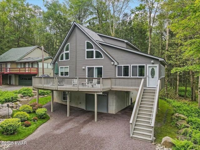 2527 Oak Cir, Lake Ariel, PA 18436 - rear view of house with a wooden deck, a carport, stairway, and asphalt driveway