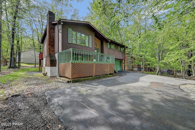 1036 Mountain Top Dr, Lake Ariel, PA 18436 - view of front of home with a chimney, driveway, and a garage