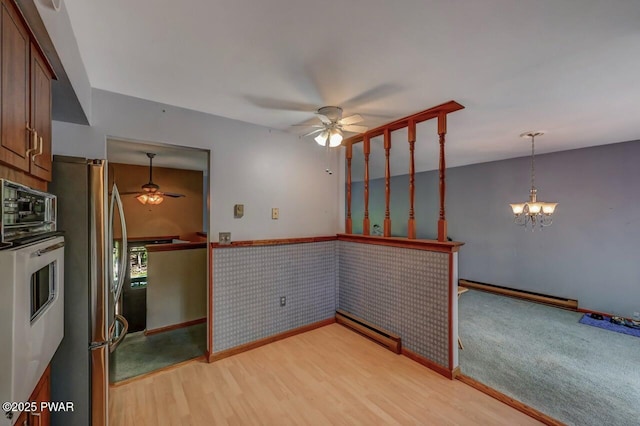 1036 Mountain Top Dr, Lake Ariel, PA 18436 - unfurnished room with a ceiling fan, a baseboard heating unit, and light wood-style floors