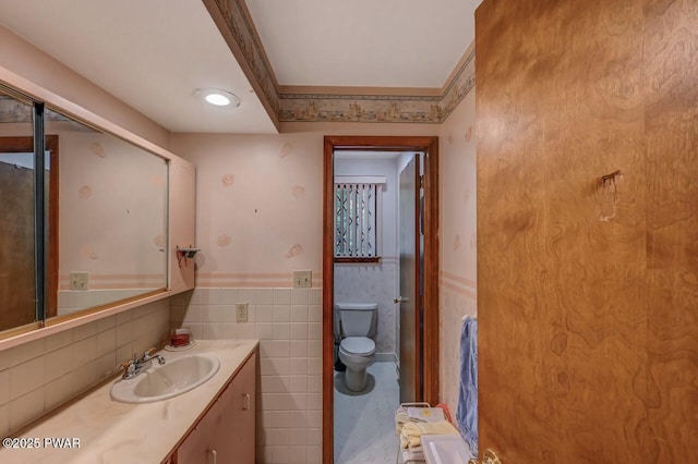 1036 Mountain Top Dr, Lake Ariel, PA 18436 - bathroom featuring a wainscoted wall, toilet, vanity, and tile walls