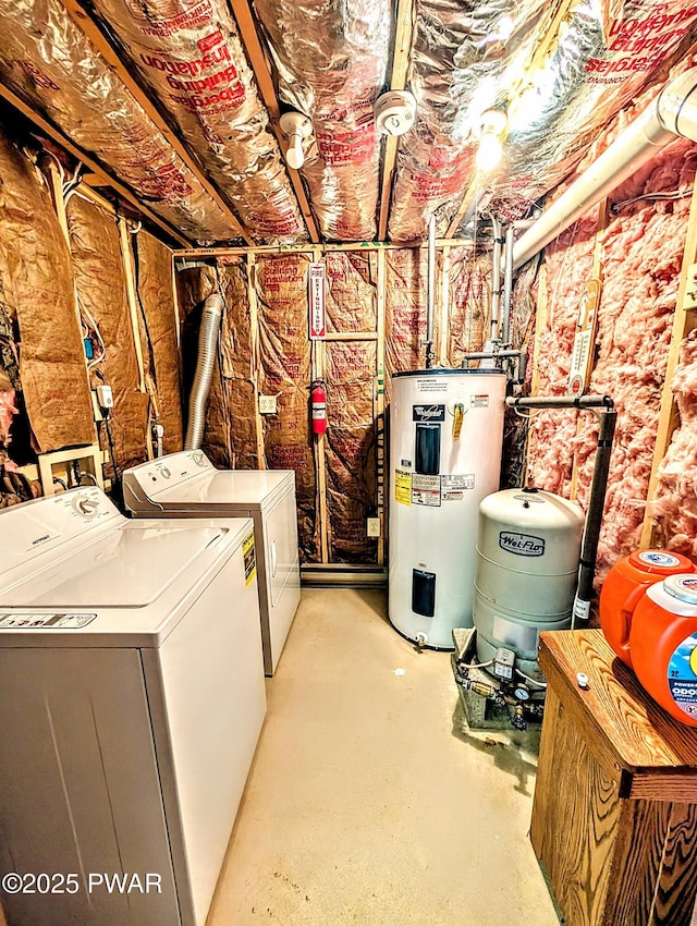 clothes washing area with washing machine and clothes dryer, laundry area, and water heater