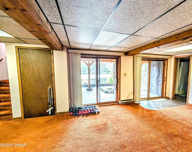 interior space featuring carpet floors, a baseboard heating unit, and stairway