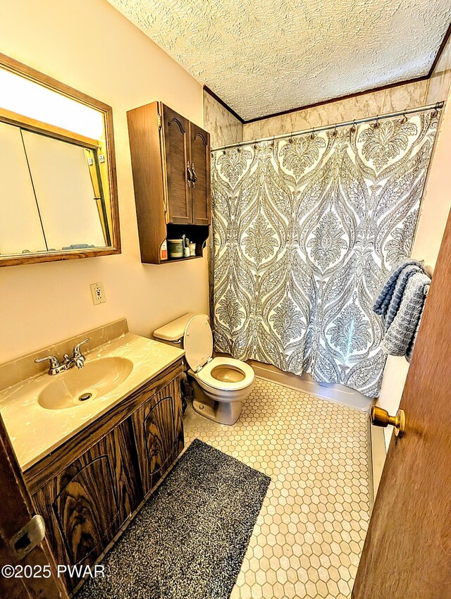 full bathroom with vanity, a textured ceiling, and toilet