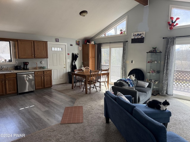 living room featuring beam ceiling, dark hardwood / wood-style flooring, sink, and high vaulted ceiling