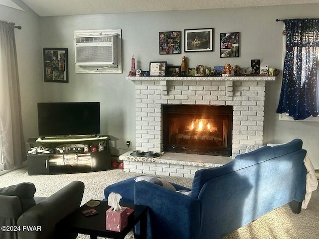 carpeted living room featuring a wall unit AC, a fireplace, and a textured ceiling