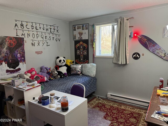 bedroom featuring a textured ceiling and a baseboard radiator