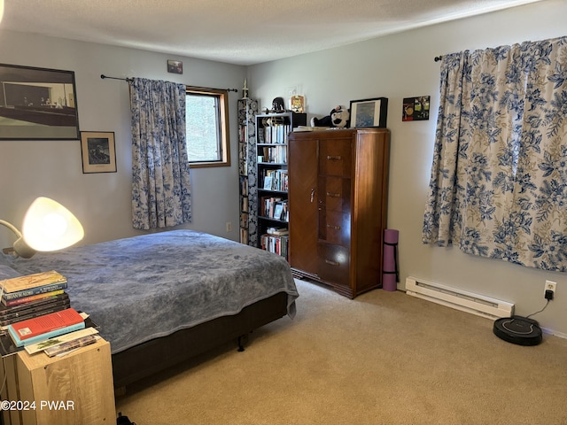 bedroom featuring baseboard heating, light colored carpet, and a textured ceiling