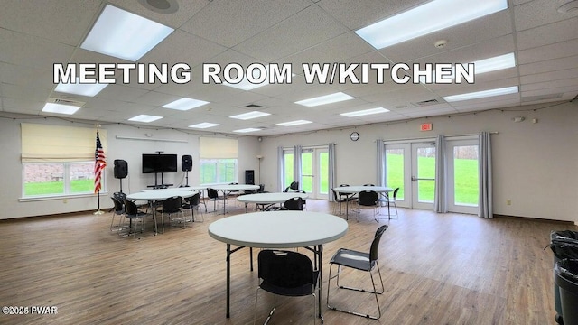 dining area with a paneled ceiling and wood-type flooring