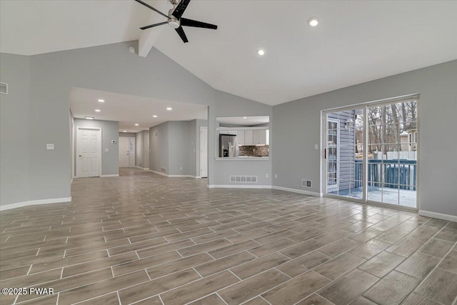 unfurnished living room with vaulted ceiling with beams and ceiling fan